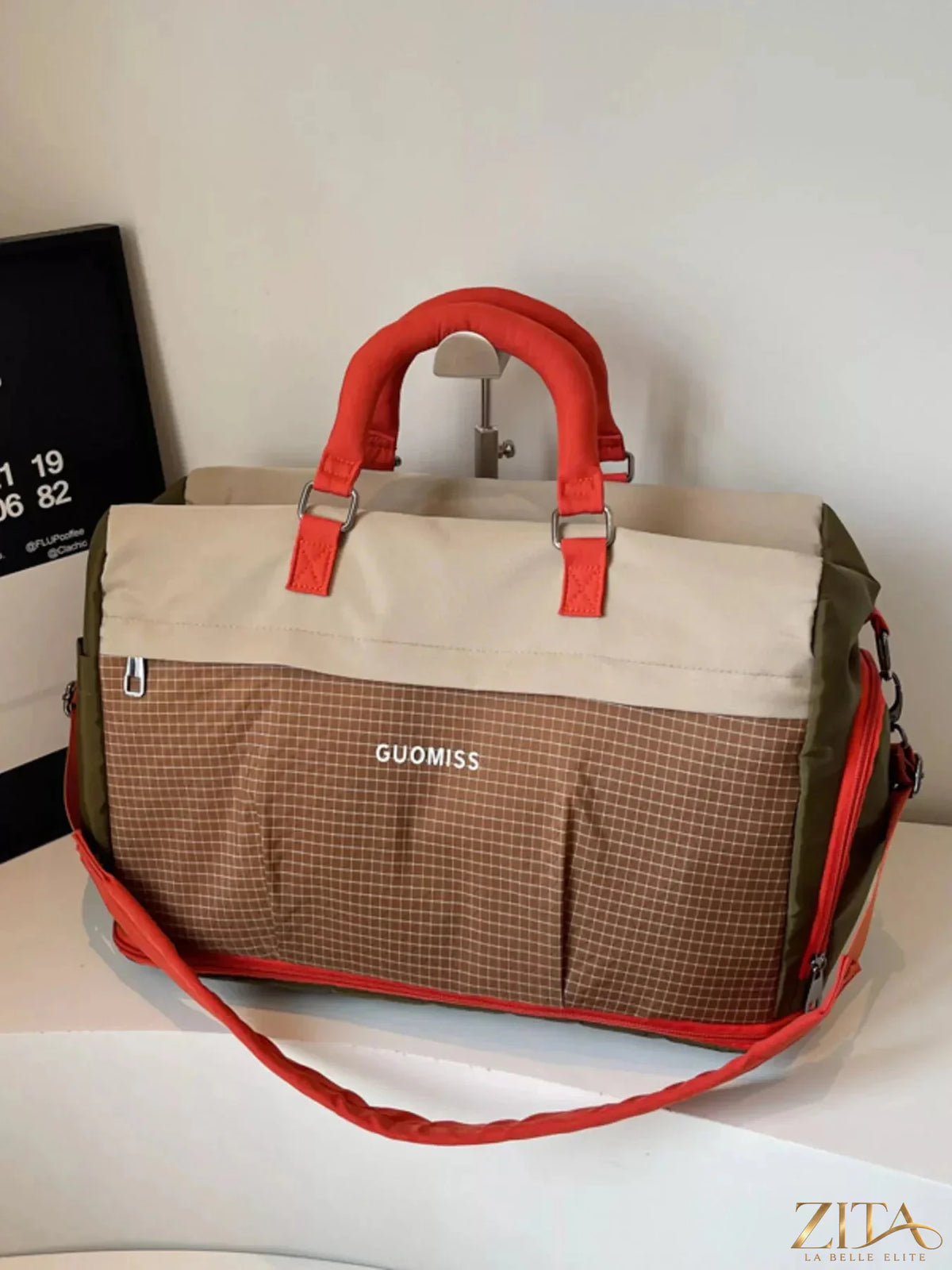 Zita La Belle Elite plaid travel bag with detachable strap, showing a stylish patterned fabric and adjustable strap in the image.