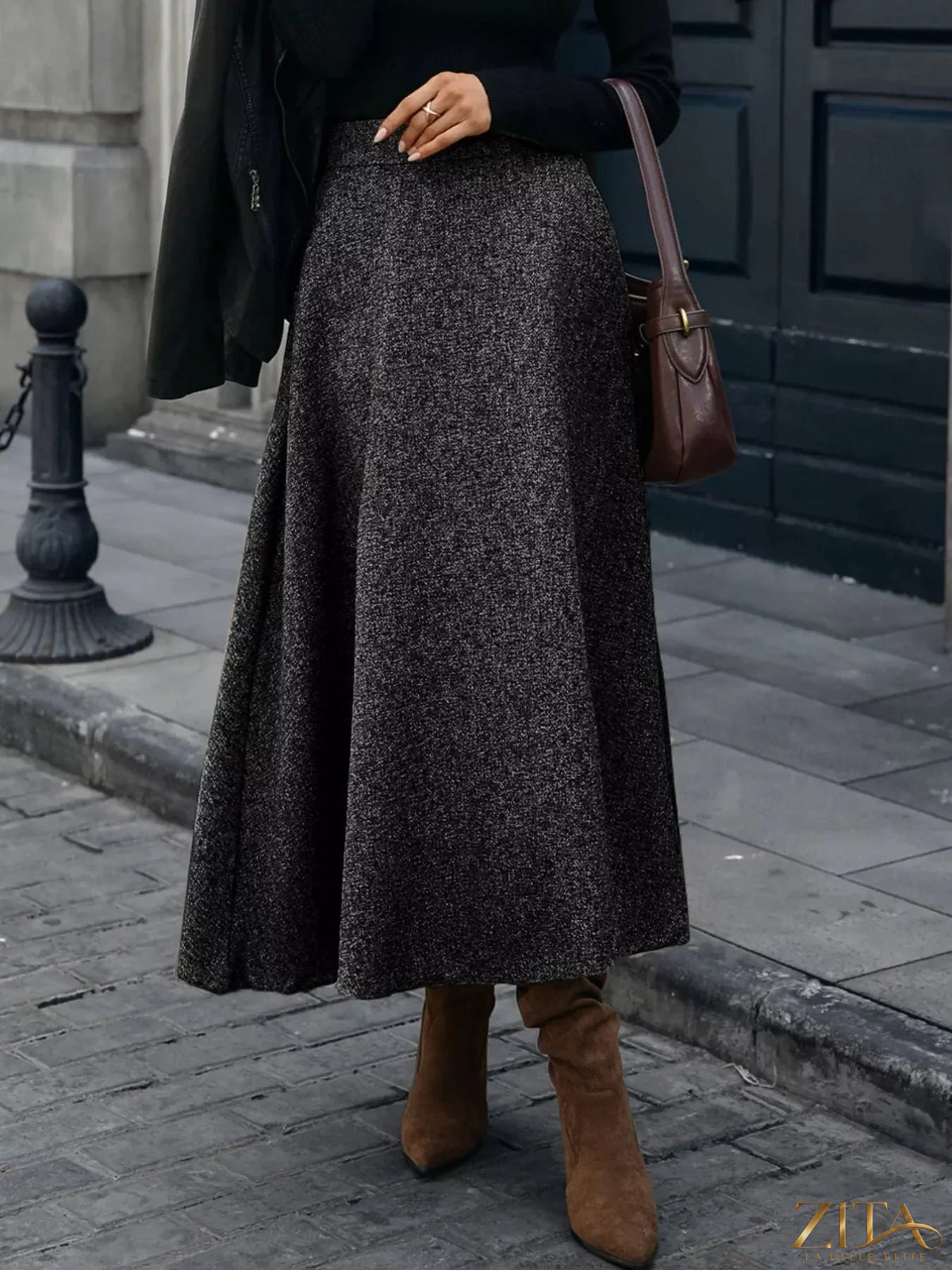 A-line midi skirt from Trendsi featuring a flowy, knee-length design with a high waist and soft fabric in neutral tones.
