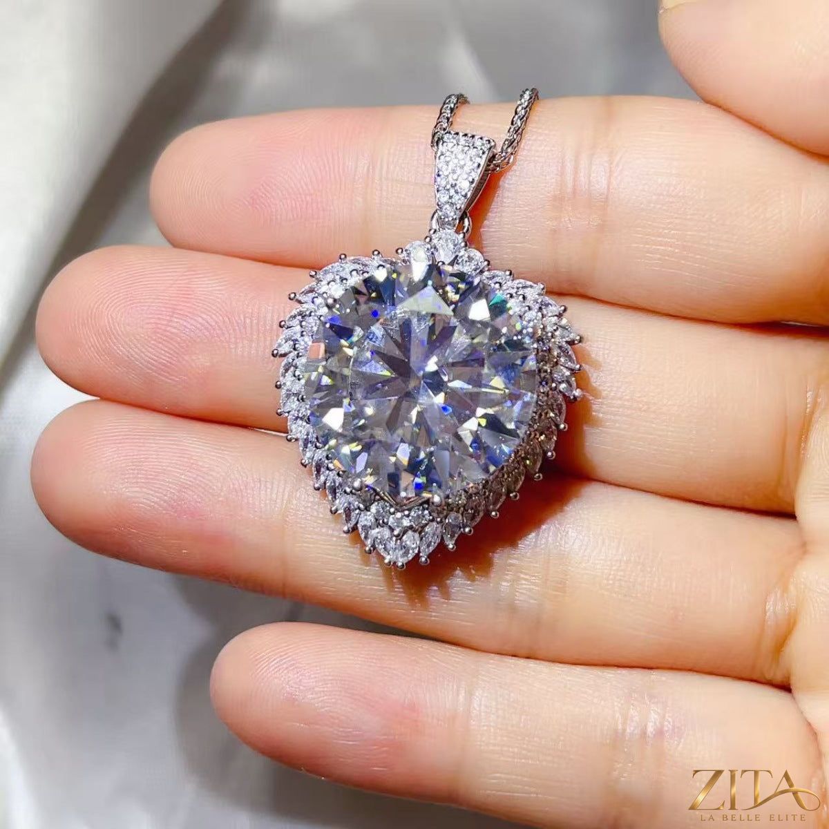 Sterling silver pendant necklace with a 20 carat moissanite gemstone, featuring a elegant and sparkling jewelry design.