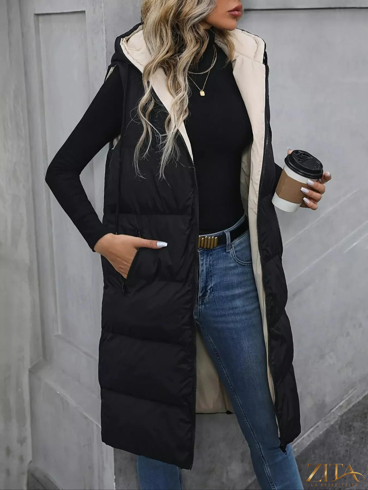 Longline padded hooded vest coat by Zita La Belle Elite, featuring a warm padded design and a stylish hood for cold weather.