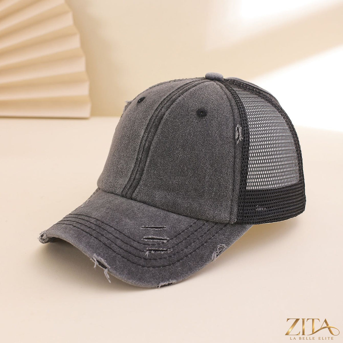 Distressed washed mesh baseball cap by Zita La Belle Elite, featuring a casual, worn-in style with breathable mesh panels.