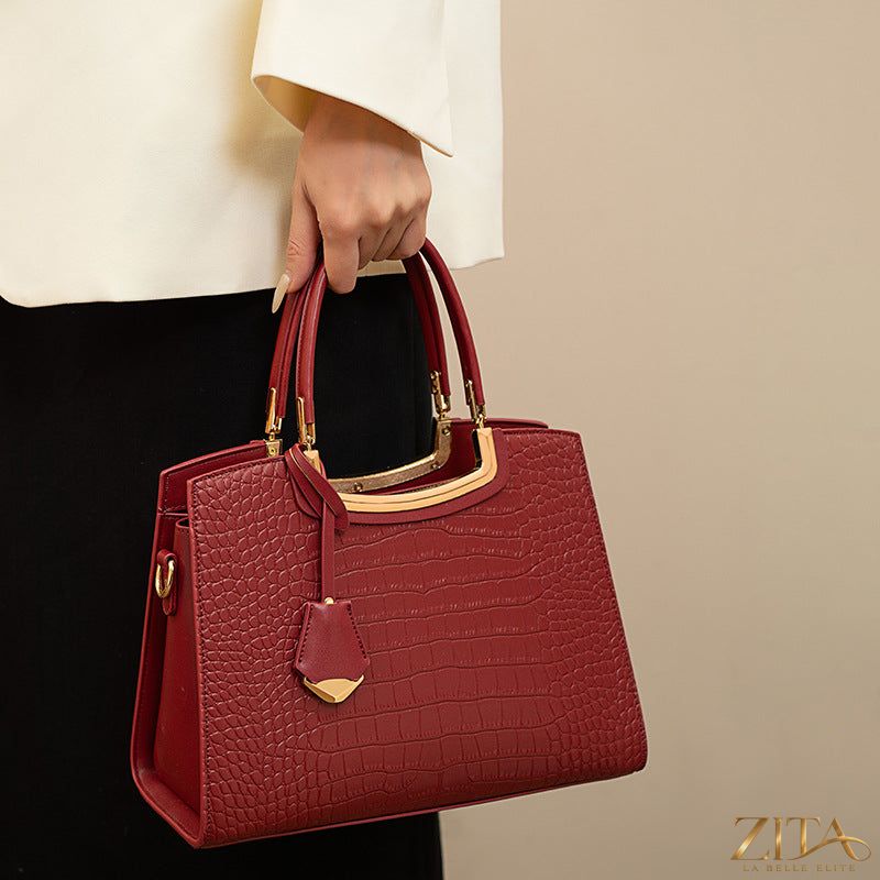 Zita La Belle Elite crocodile embossed leather top handle handbag with structured design and gold-tone hardware.