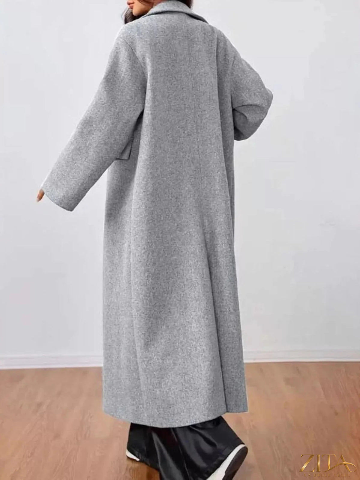 Zita La Belle Elite wool-blend longline overcoat hanging on a rack, showcasing its tailored fit and classic design.