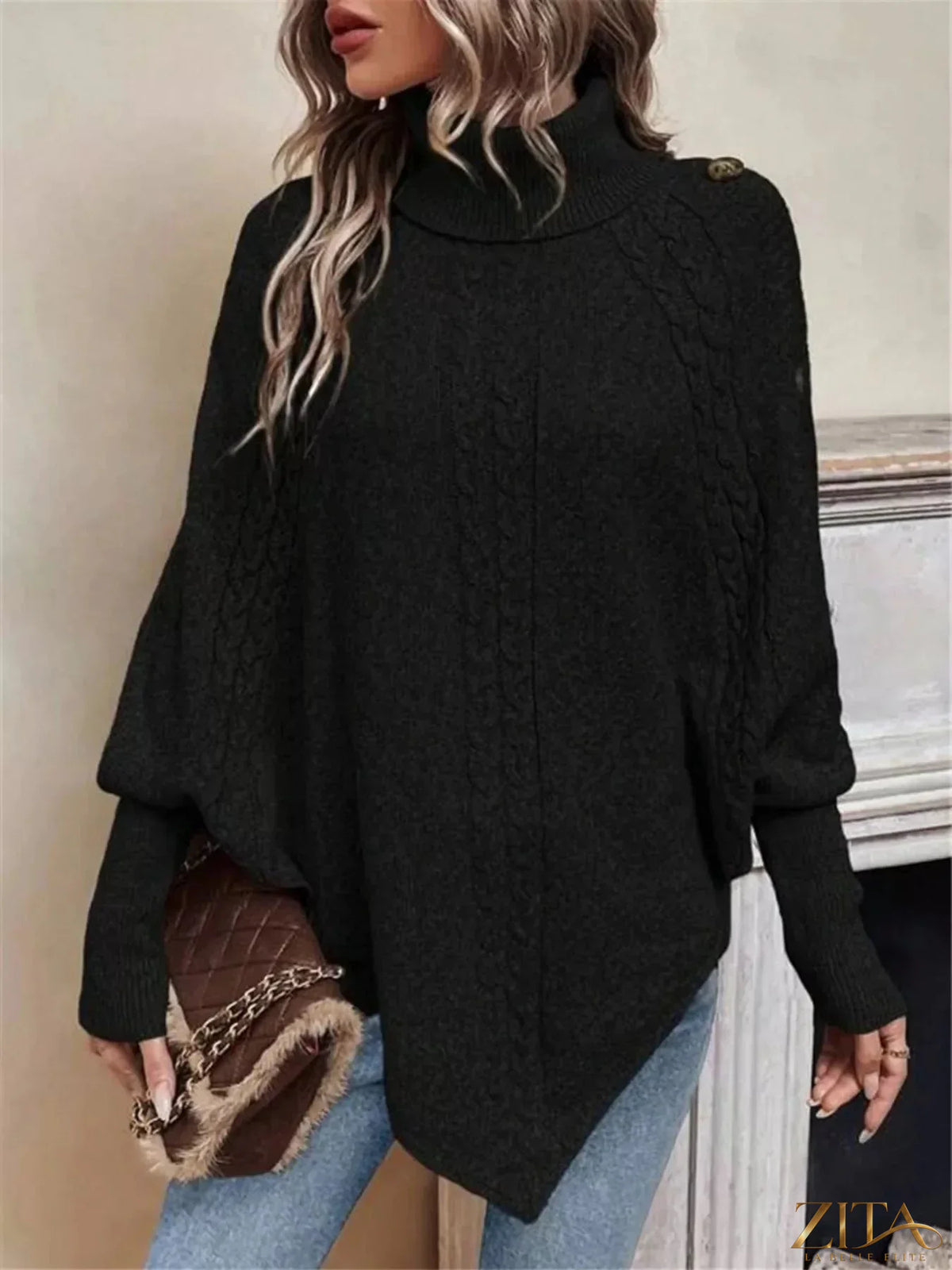 Cable knit turtleneck cape sweater by Trendsi, featuring a cozy, oversized design with a turtleneck and textured knit pattern.