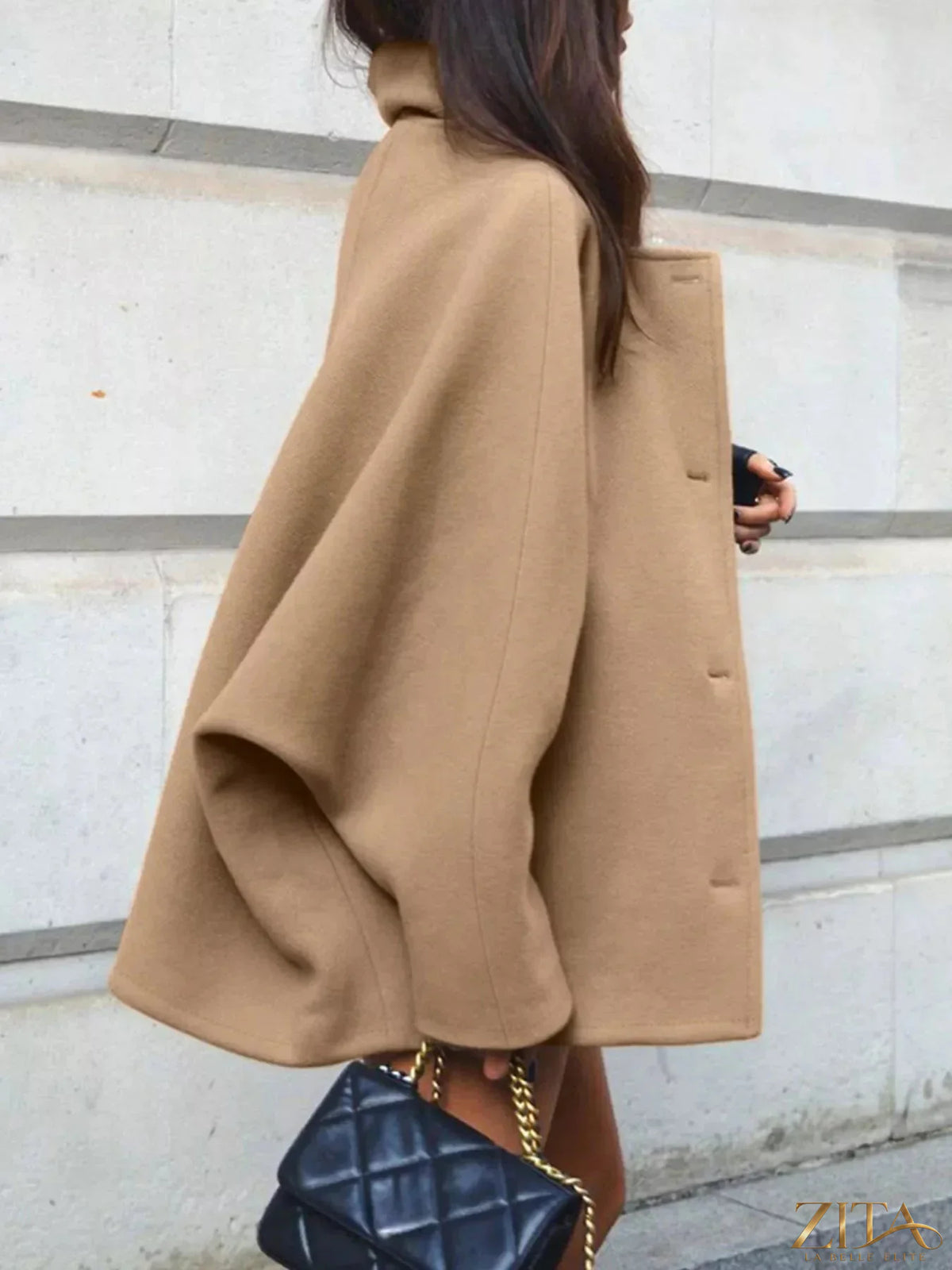 Zita La Belle Elite oversized lapel collar button-down coat hanging on a wooden hanger, showcasing its classic design and tailored fit.
