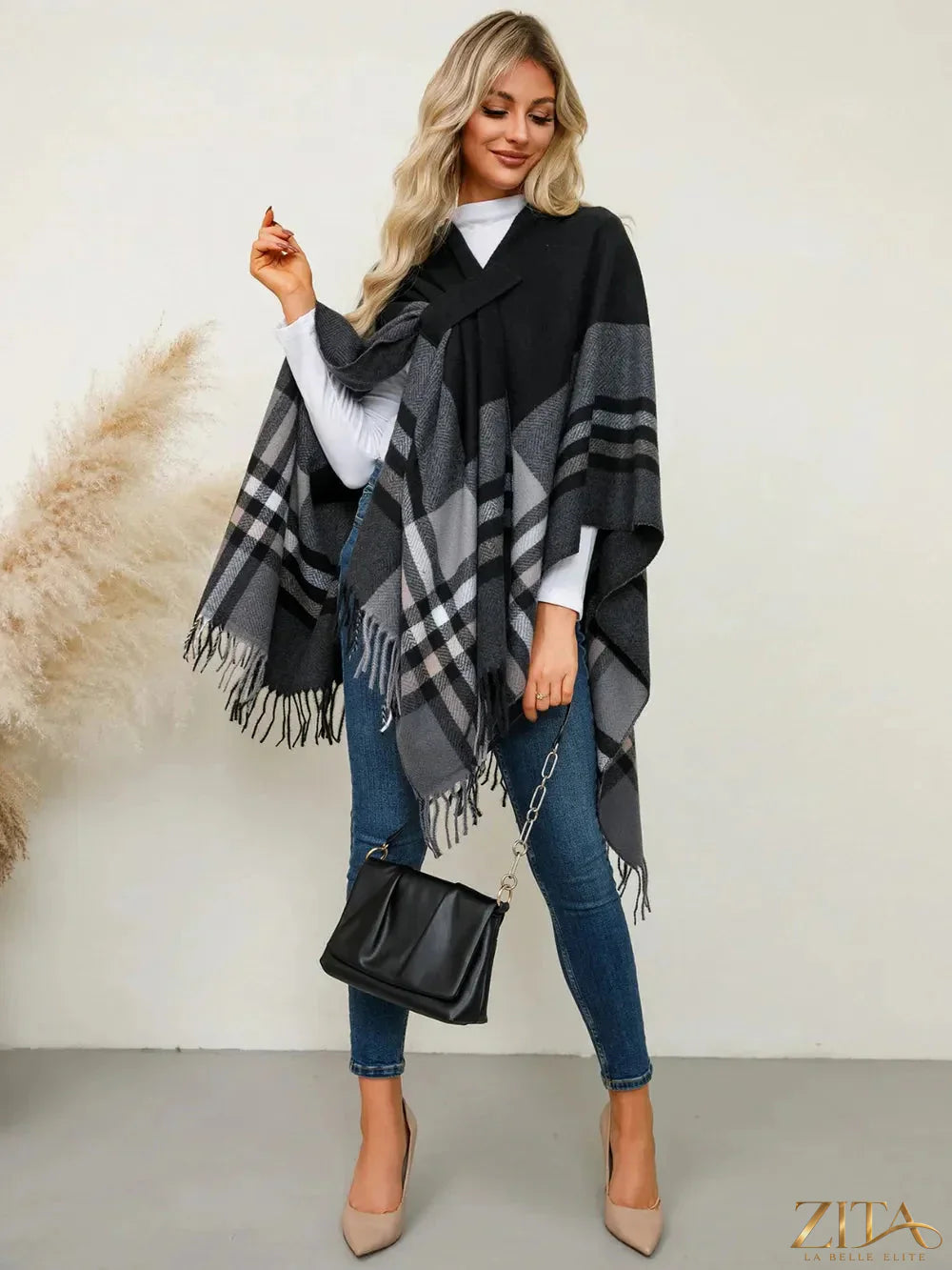 Fringe contrast plaid poncho from Trendsi featuring a cozy, stylish layered look with fringed edges and a classic plaid pattern.