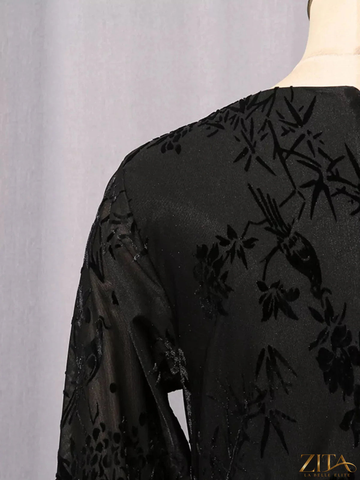 Black ruched long sleeve mini dress by Trendsi, featuring fitted design and stylish neckline for a chic look.