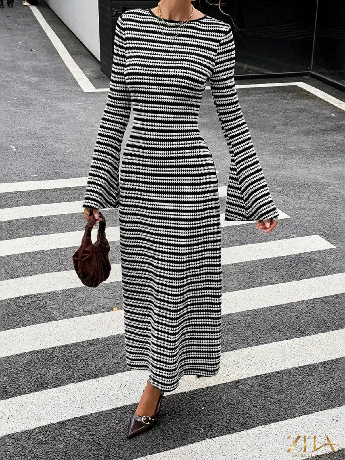 Zita La Belle Elite striped flared sleeves sweater dress hanging on a hanger, showcasing its stylish design and vibrant pattern.