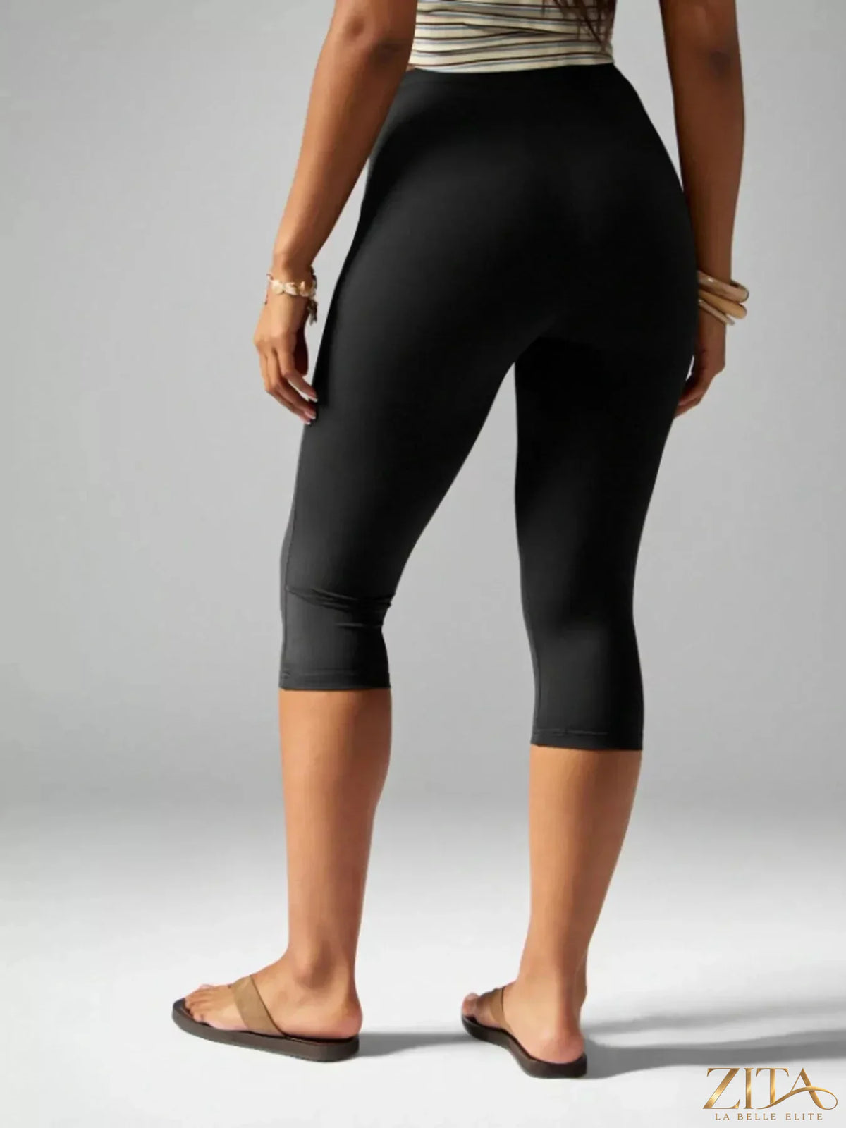 Zita La Belle Elite high-waisted active capri leggings in black, featuring a close-up view of the stretchy, form-fitting fabric.