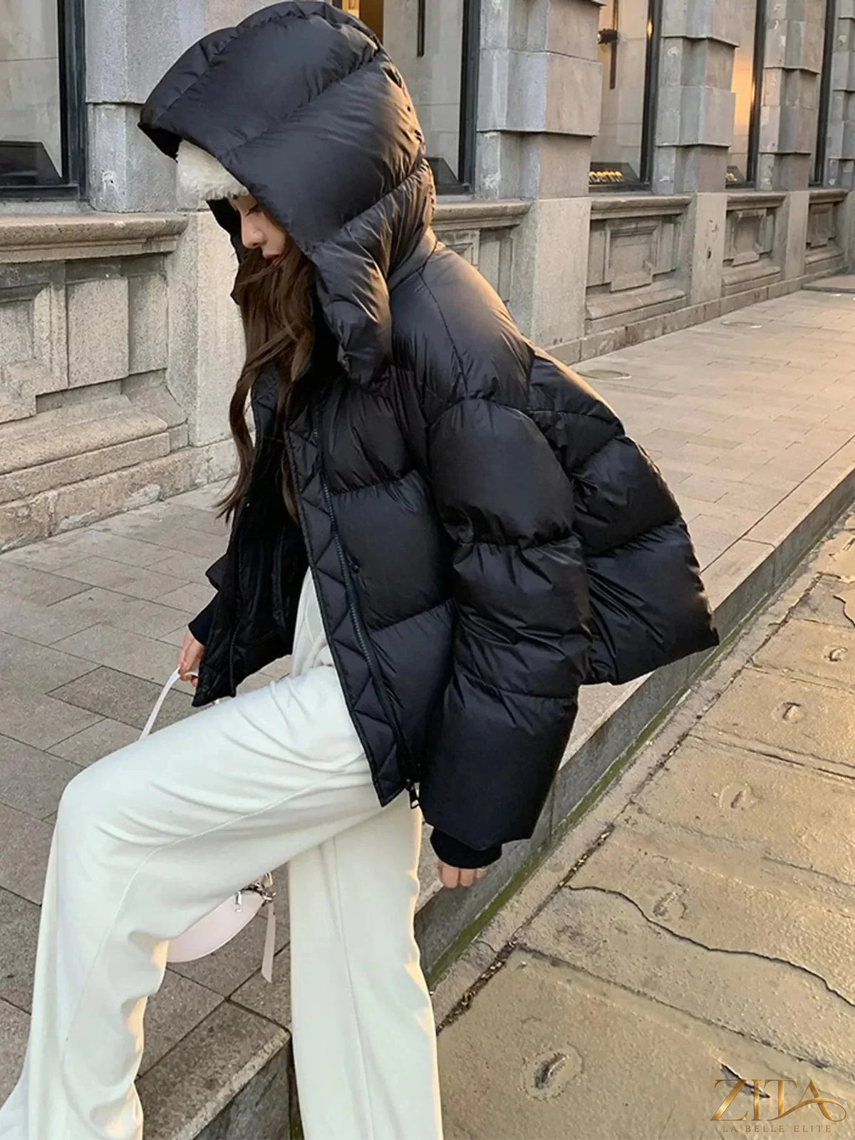 Zita La Belle Elite quilted hooded puffer jacket in black with a shiny, quilted design and adjustable hood, front view.