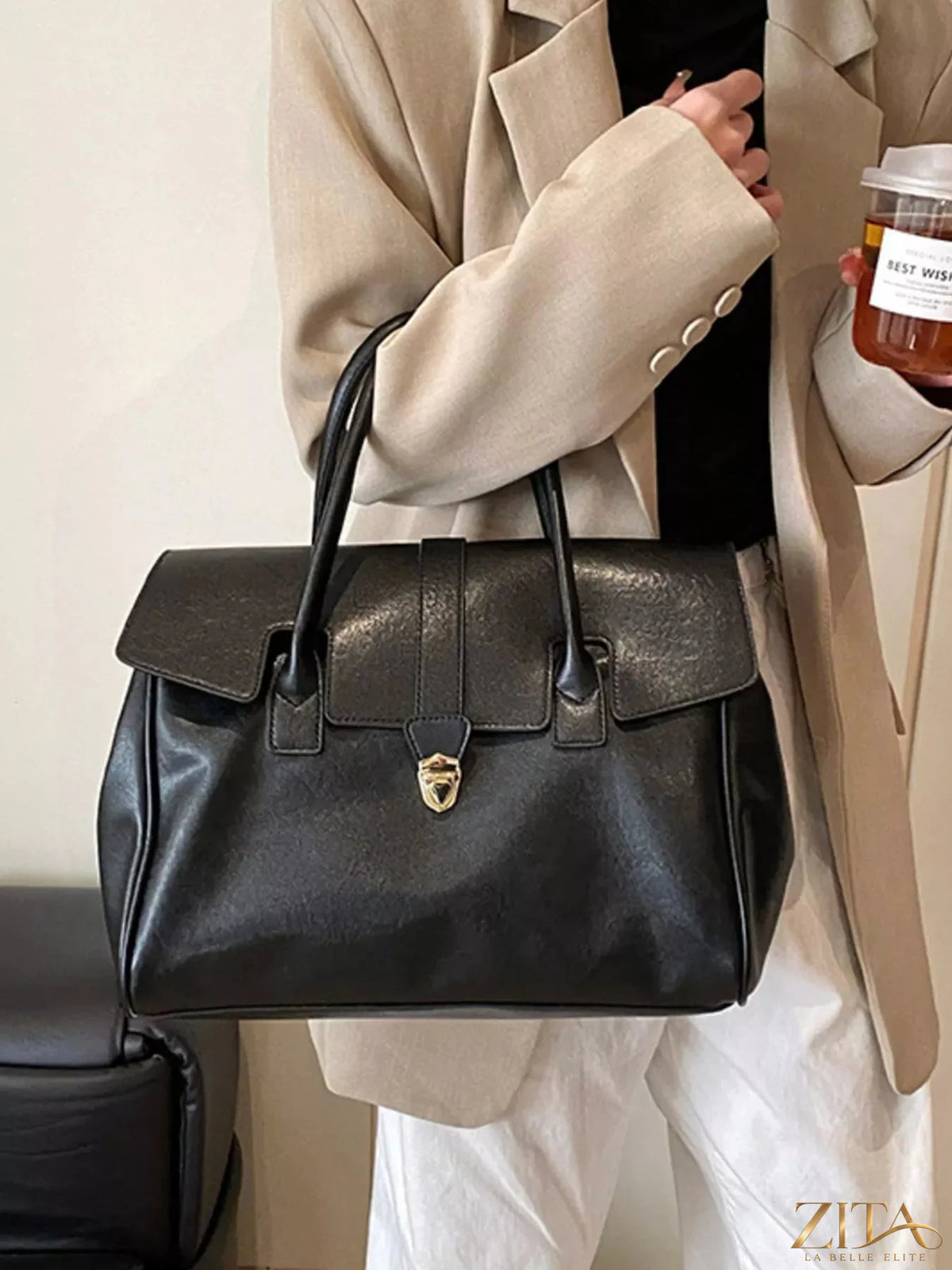 Trendsi Buckle PU Leather Handbag showing a stylish handbag with buckle detail and smooth leather surface.