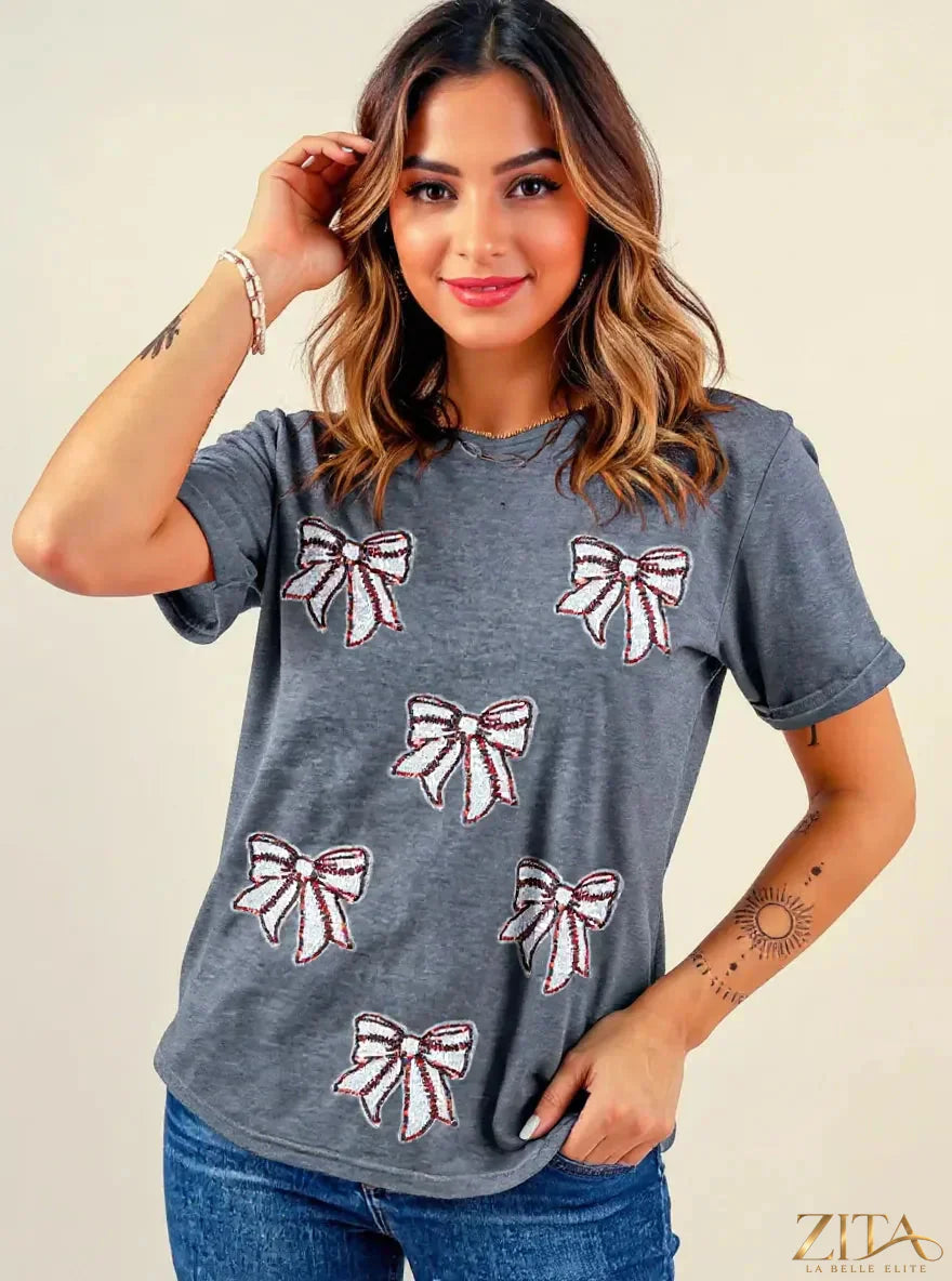 Sequin bow short sleeve T-shirt by Trendsi featuring a playful design with shiny sequins and a casual fit.