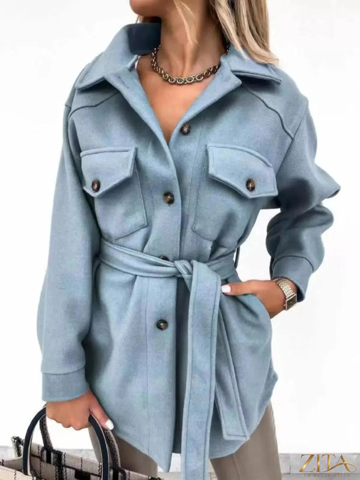 Zita La Belle Elite button-down tie waist coat in neutral fabric, shown on a hanger with a classic collar and long sleeves.