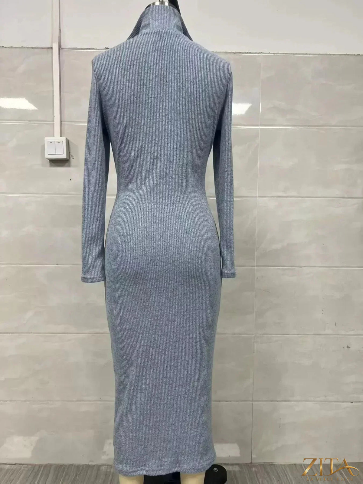 Zita La Belle Elite ribbed knit V-neck sweater dress, shown in a close-up image highlighting the textured fabric and V-neck design.
