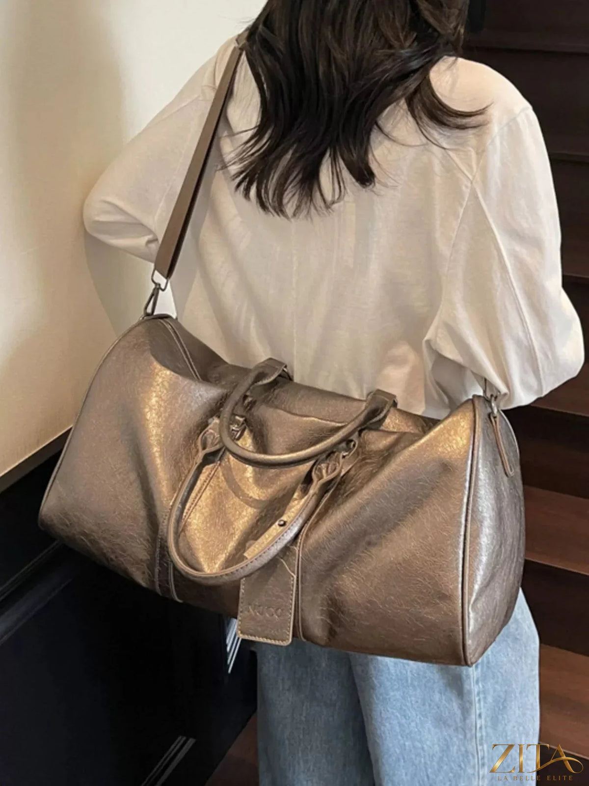 Trendsi PU leather duffle bag with adjustable shoulder strap, multiple zippered compartments, and sturdy handles for travel or gym use.