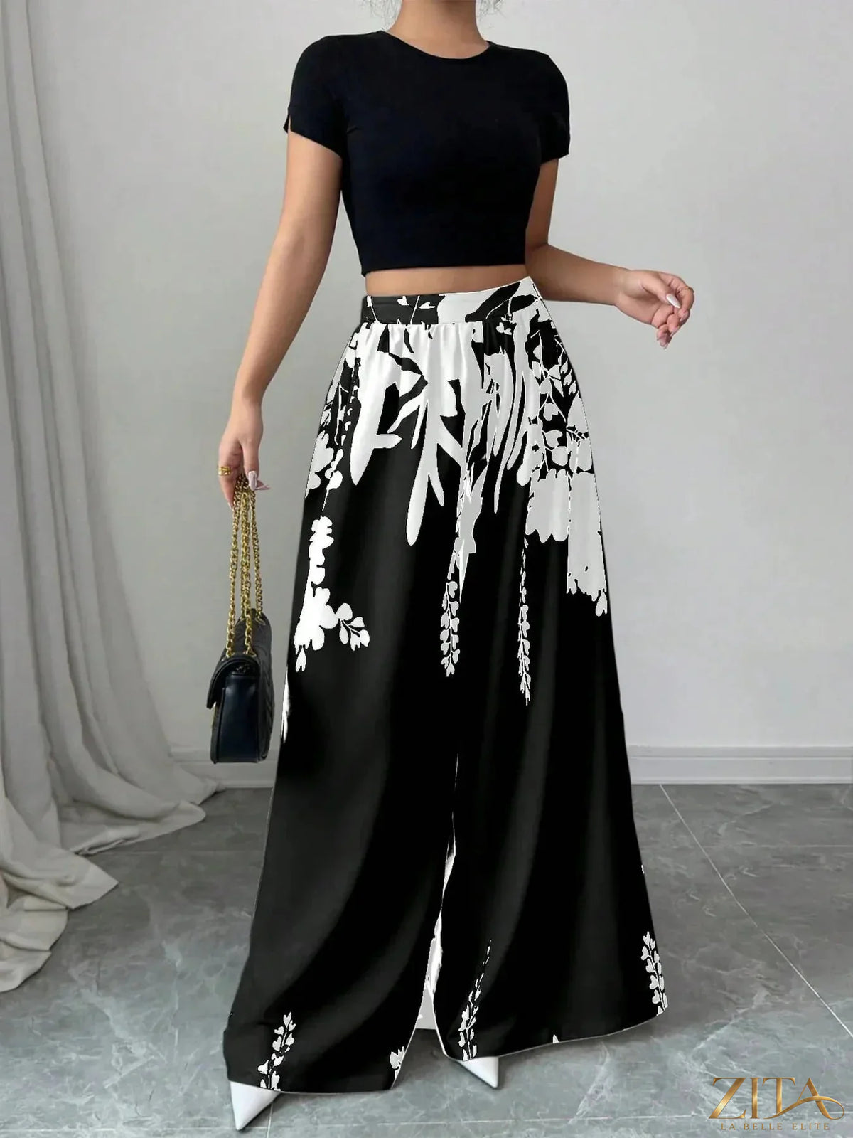 Zita La Belle Elite printed wide-leg pants with colorful floral pattern and flowing fabric on a model.