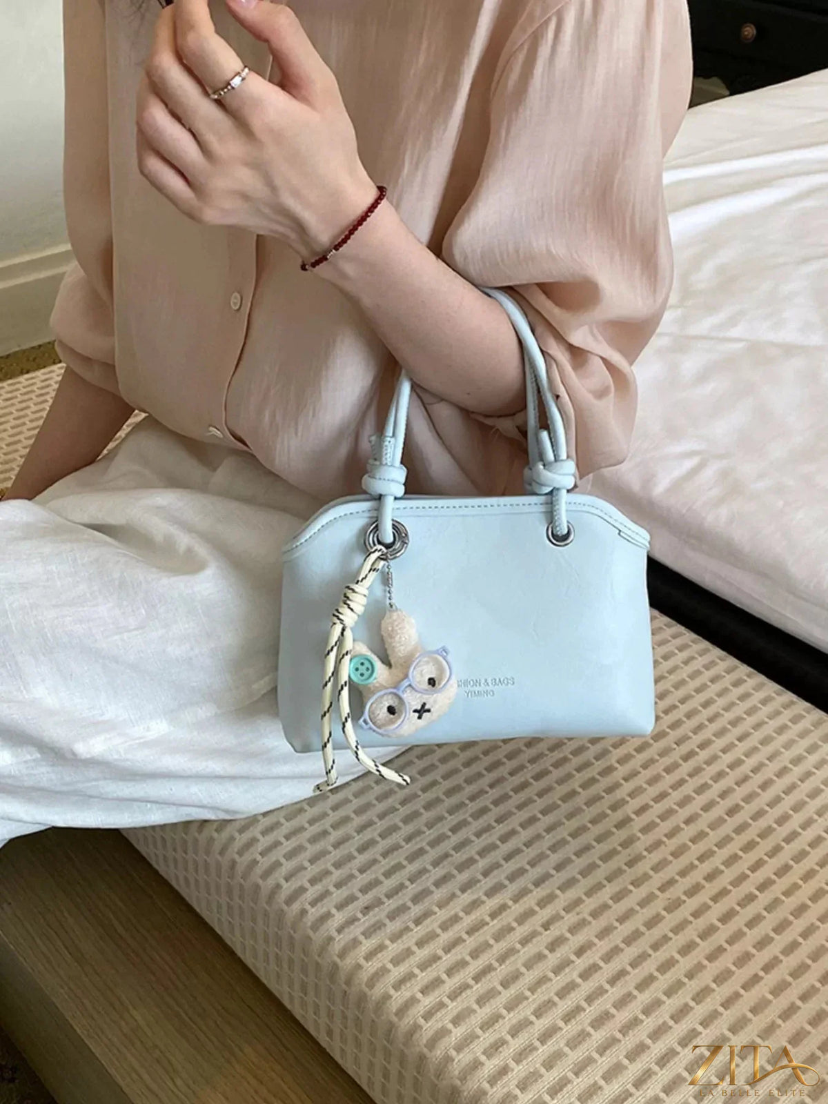 Trendsi PU leather handbag with gold-tone hardware, featuring a sleek design and top handle for stylish everyday use.
