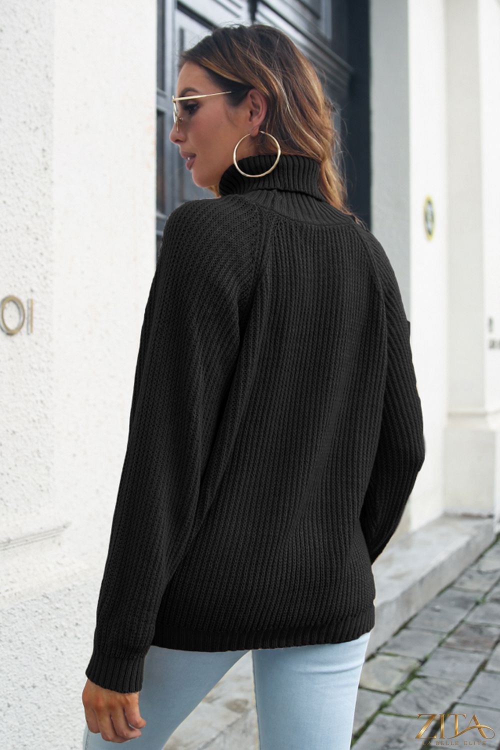 Zita La Belle Elite rib-knit turtleneck sweater in neutral color, close-up showing textured fabric and fitted style.
