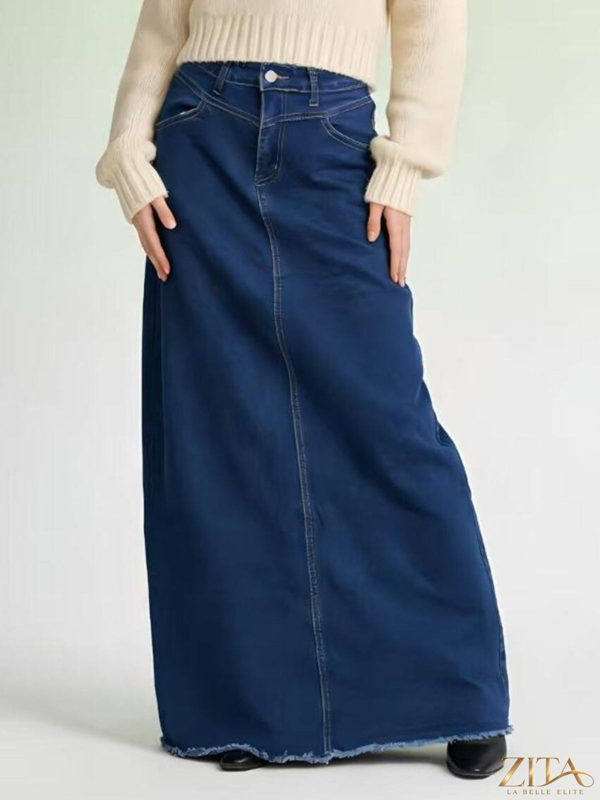 Raw hem maxi denim skirt by Zita La Belle Elite featuring a flowing silhouette and distressed hem detail.