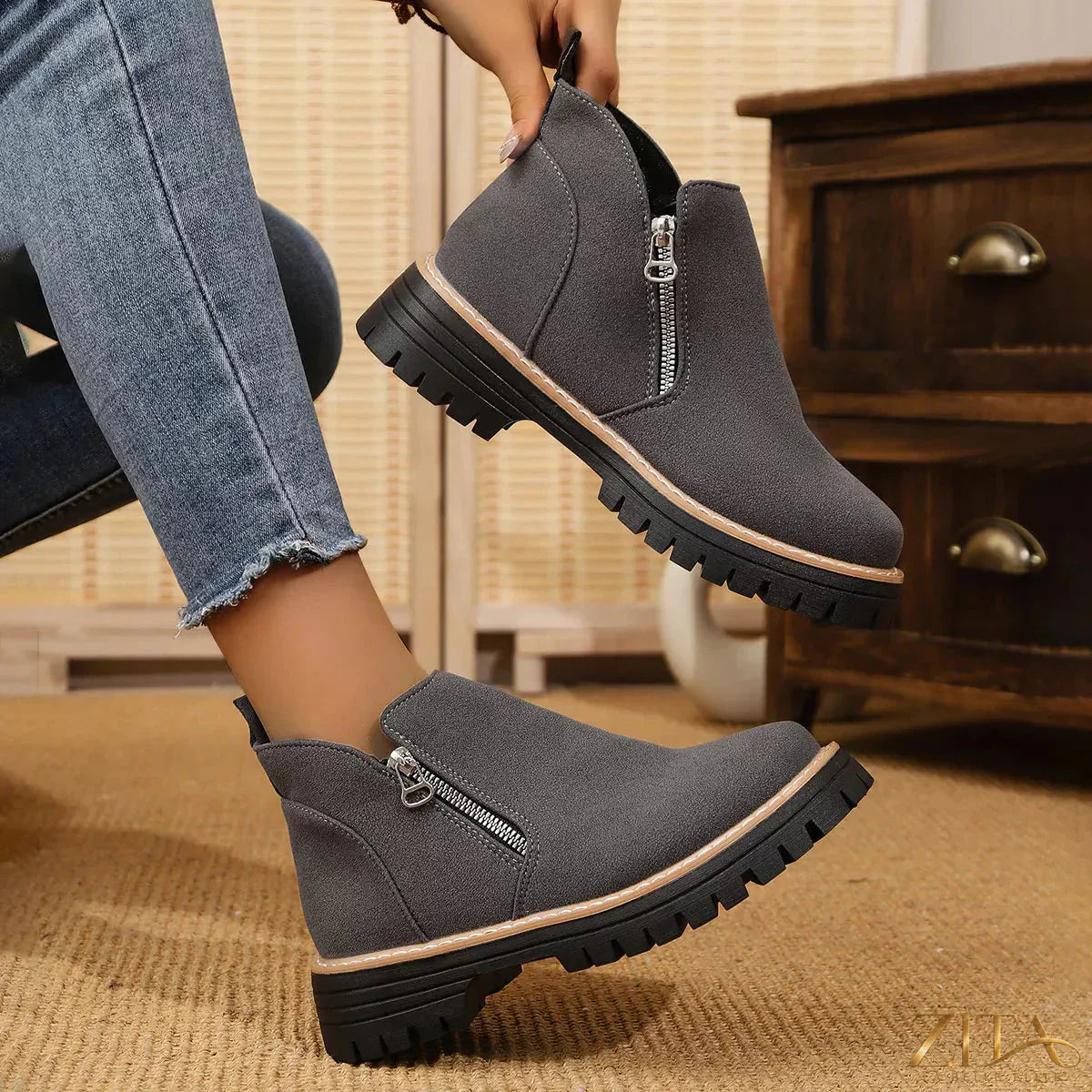 Zita La Belle Elite ankle boots with zipper accent, featuring stylish black leather design and pointed toe, on a neutral background.