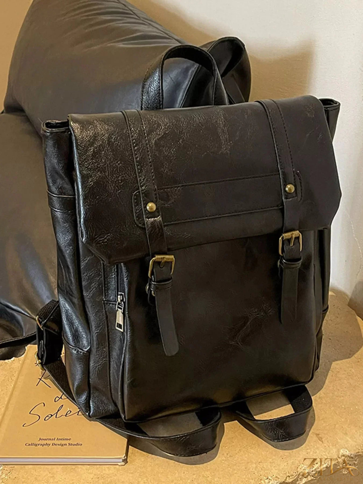 Leather flap backpack bag by Trendsi featuring a stylish design with adjustable straps and a front flap pocket.