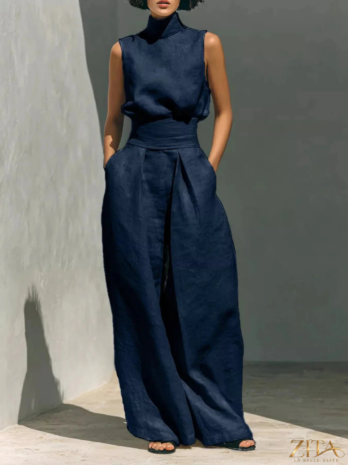 Sleeveless turtleneck top and wide-leg pants set by Trendsi, featuring a stylish, coordinated outfit with a modern silhouette.