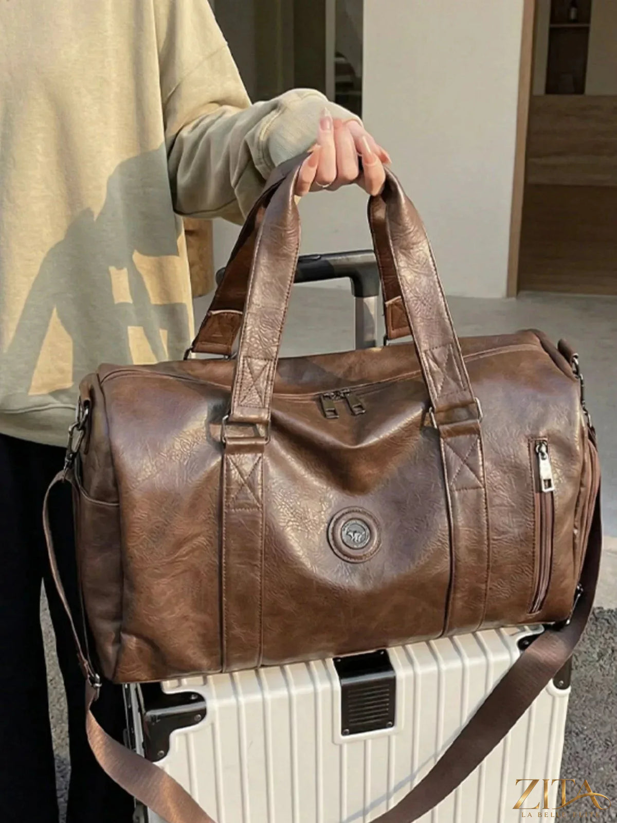 Trendsi PU leather duffel bag with sturdy handles, spacious interior, and sleek black design for travel and gym use.