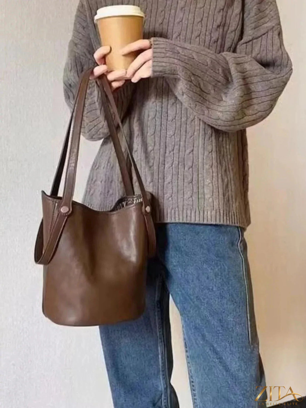 Leather bucket tote bag by Zita La Belle Elite with sturdy handles and spacious interior, crafted from smooth, high-quality leather.