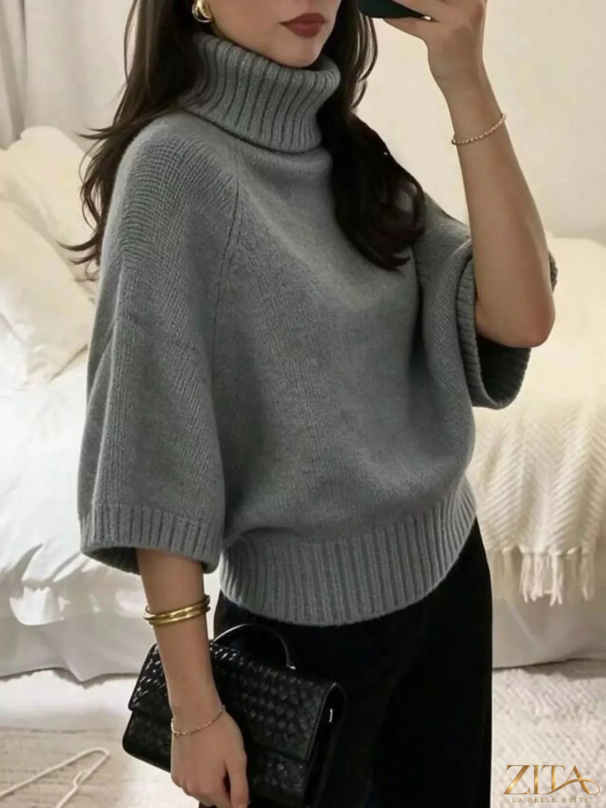 Black turtleneck batwing sleeve sweater by Trendsi, showcasing a cozy knit design with wide, flowing sleeves and a fitted turtleneck.