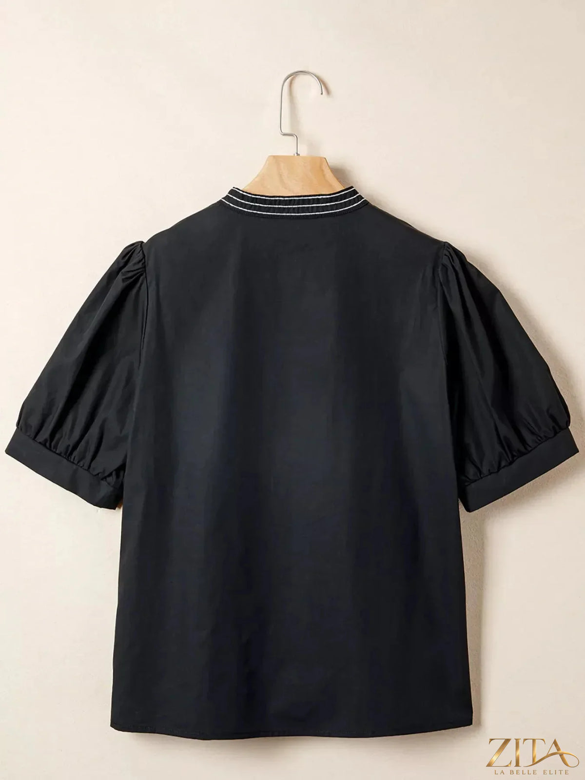 Zita La Belle Elite notched puff sleeve blouse featuring a stylish design, shown in a close-up image highlighting fabric and details.