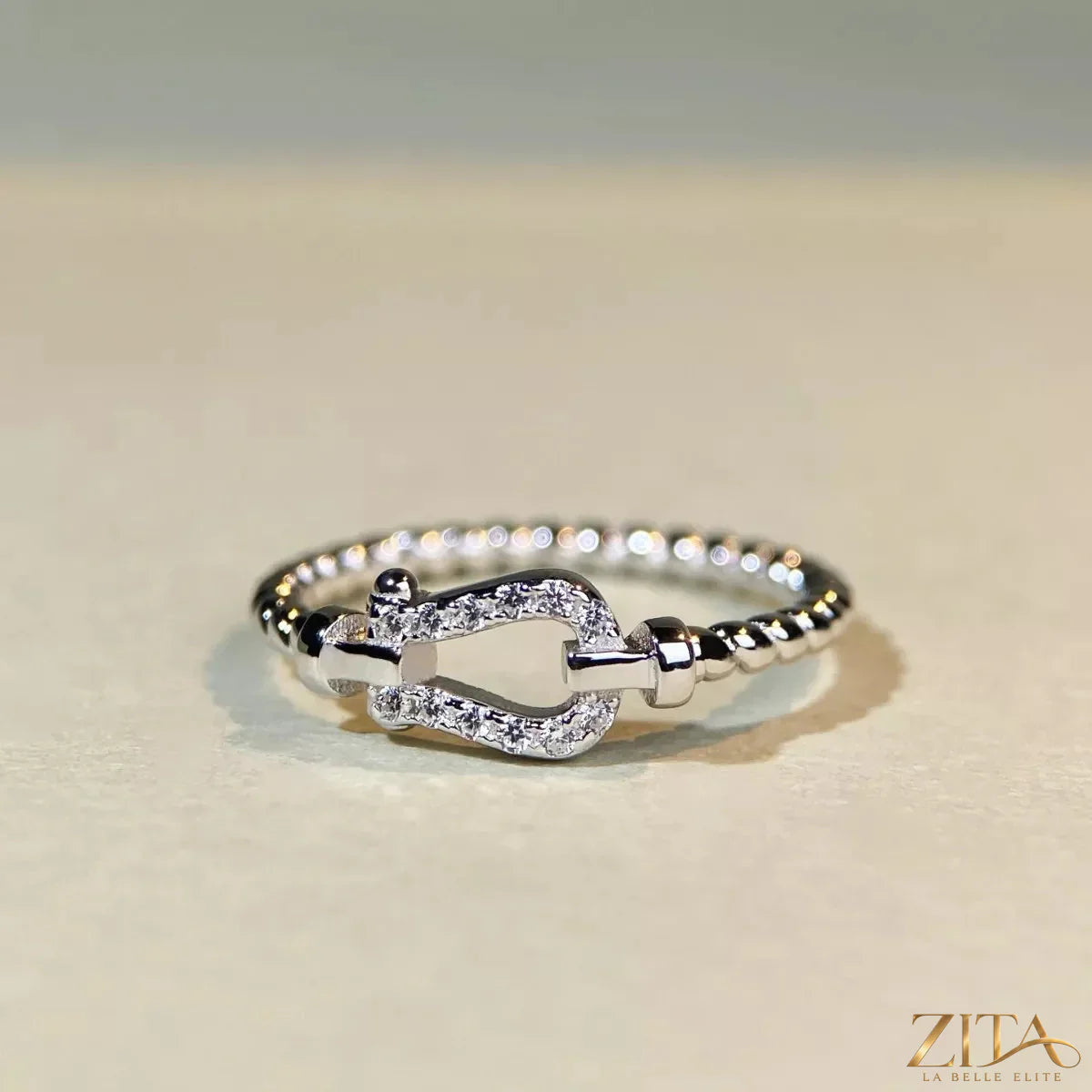 925 sterling silver zircon horseshoe-shaped ring by Zita La Belle Elite, featuring a sparkling zircon gemstone and a polished silver finish.