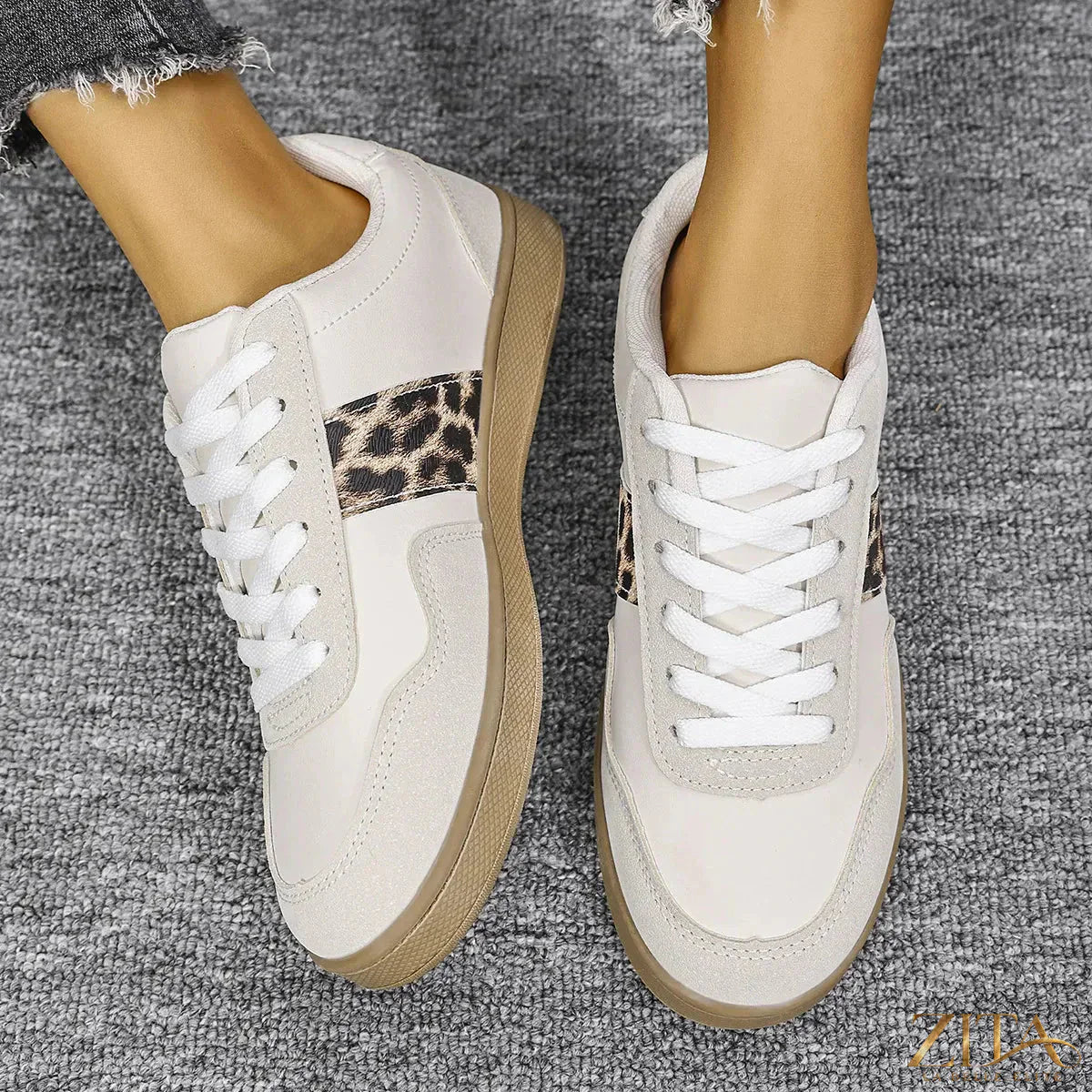 Leopard lace-up round toe sneakers by Zita La Belle Elite with animal print and white rubber sole on a white background.