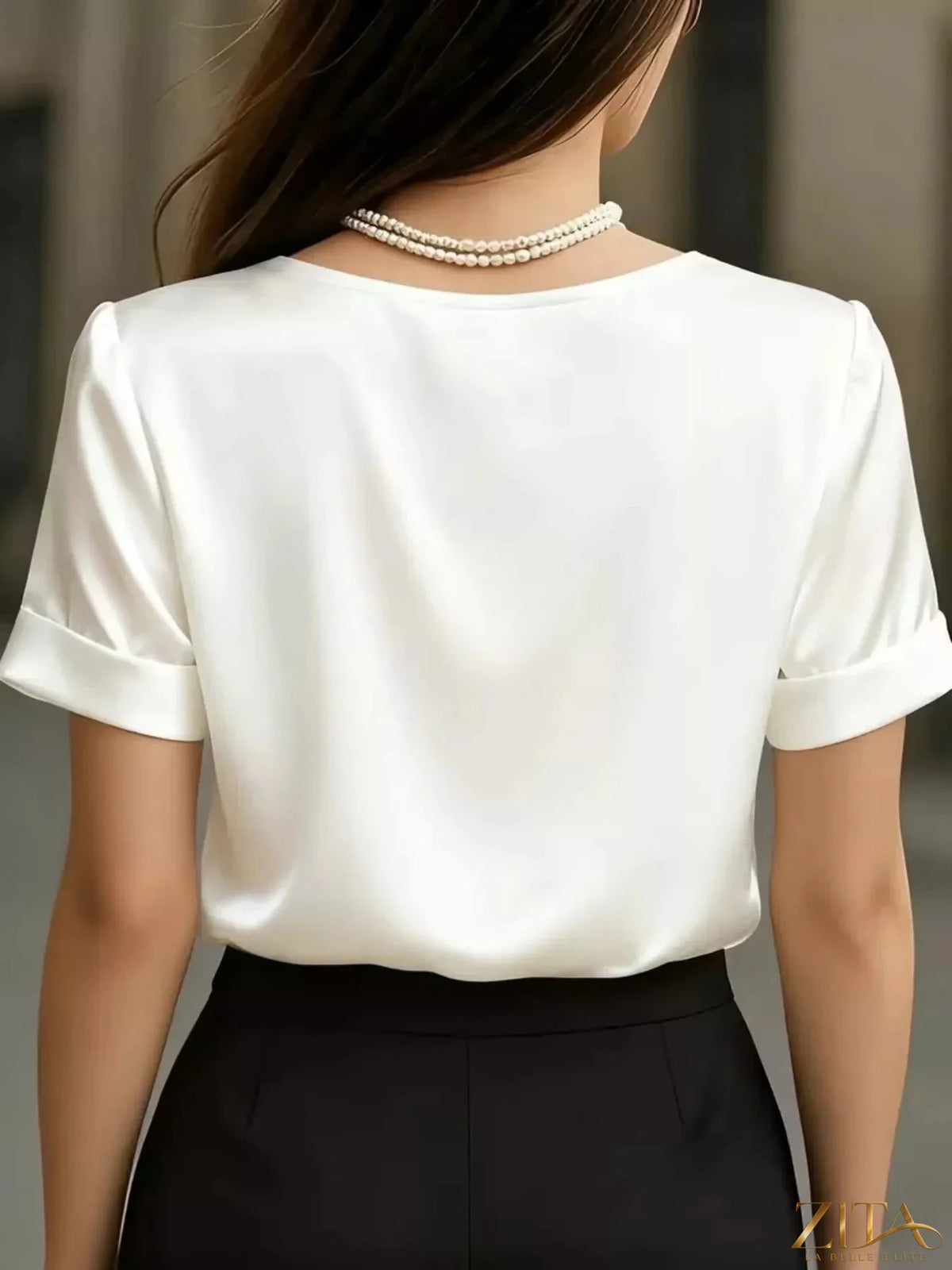 V-neck satin blouse by Zita La Belle Elite featuring smooth fabric and elegant design on a hanger.