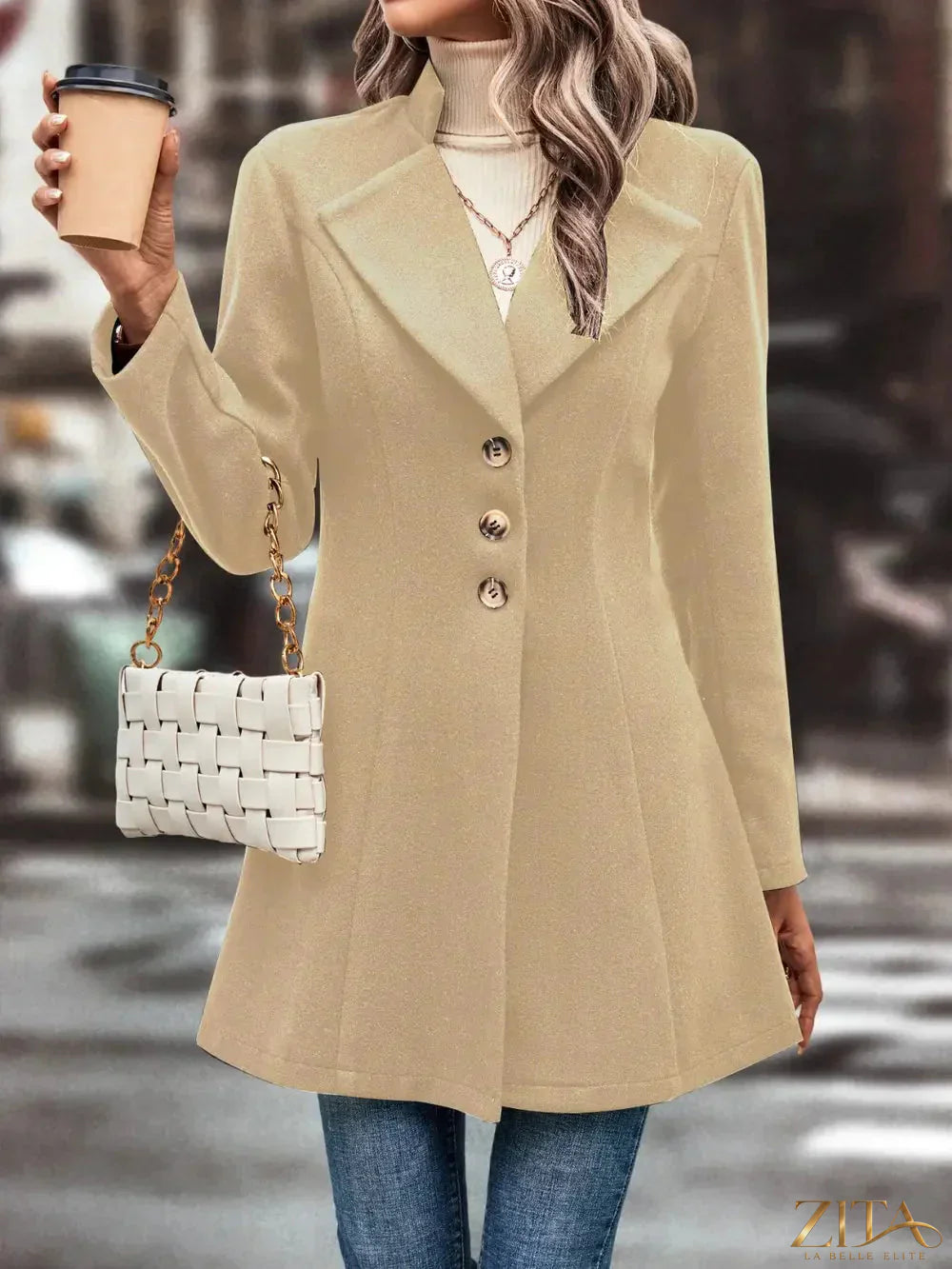 Zita La Belle Elite button-up longline coat displayed on a model, featuring a tailored fit and classic lapel collar in a neutral color.