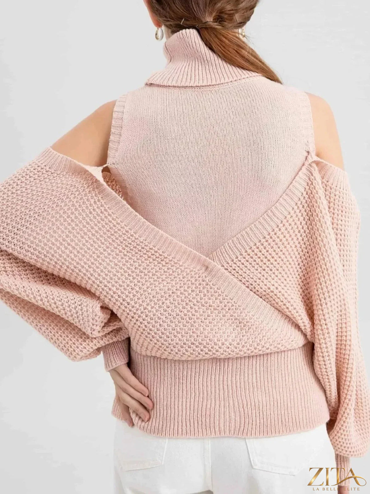 Waffle knit cold shoulder turtleneck sweater by Trendsi featuring a cozy, textured design with cut-out shoulders and a fitted turtleneck.