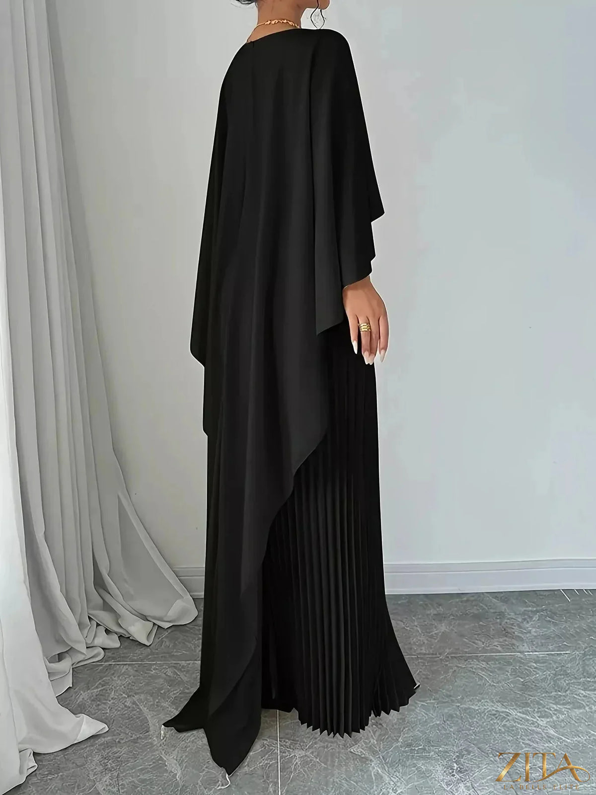 Trendsi cape pleated maxi dress featuring flowing fabric and elegant design, perfect for formal or casual occasions.