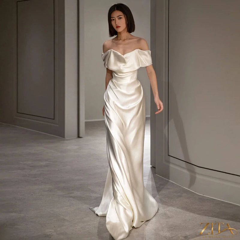 Elegant French white off-shoulder wedding dress by Zita La Belle Elite, featuring a light, flowing design for women.