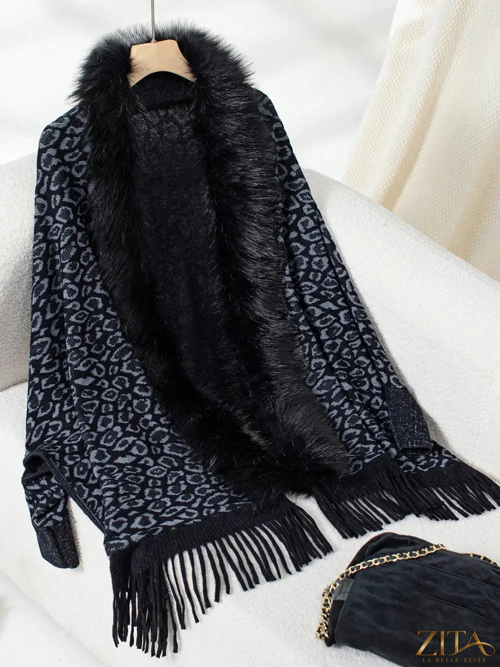 Leopard print fringe open front long sleeve poncho from Trendsi, featuring a stylish animal pattern and flowing design.