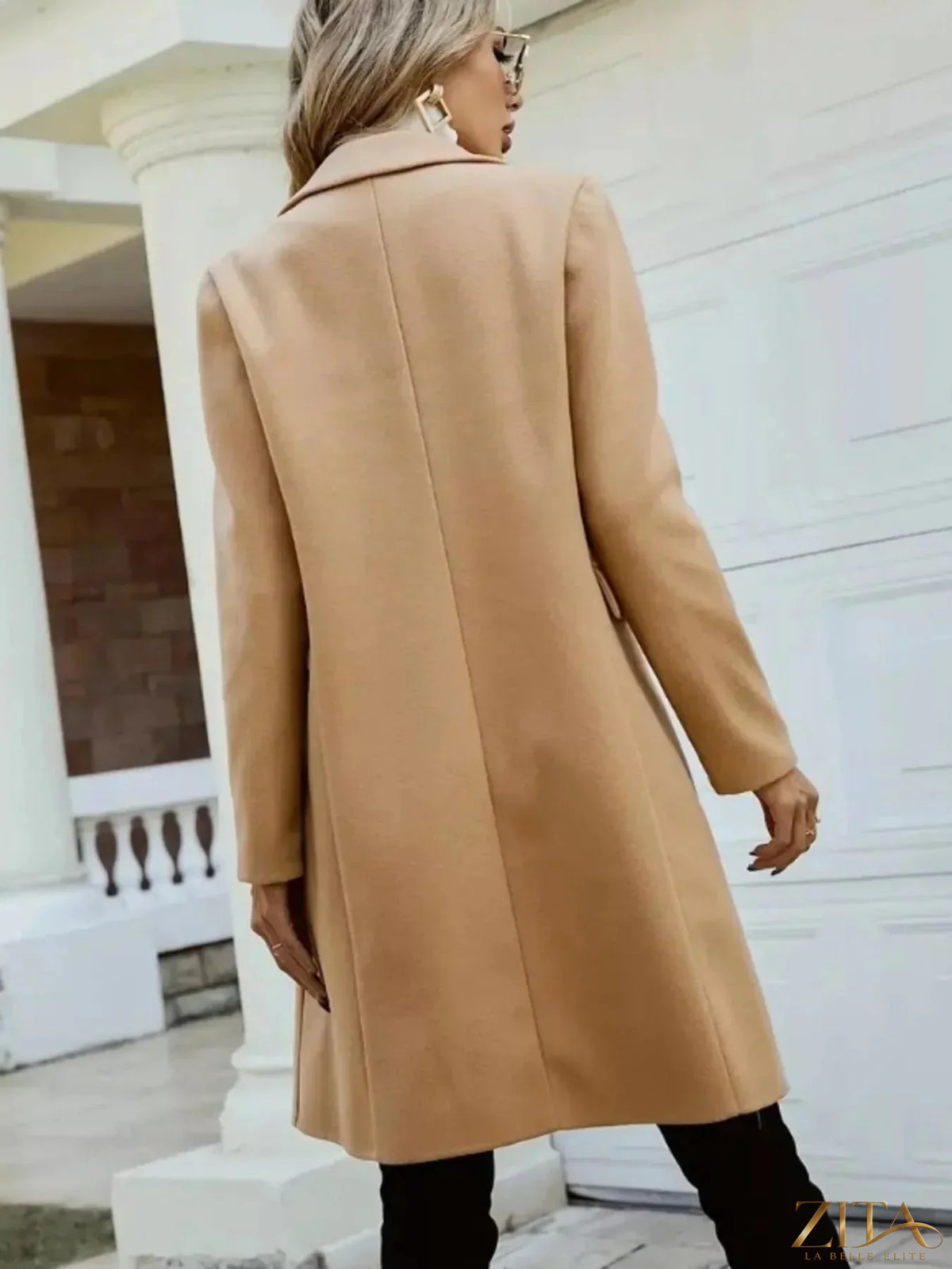 Zita La Belle Elite double-breasted longline coat in neutral fabric, displayed on a hanger against a white background.