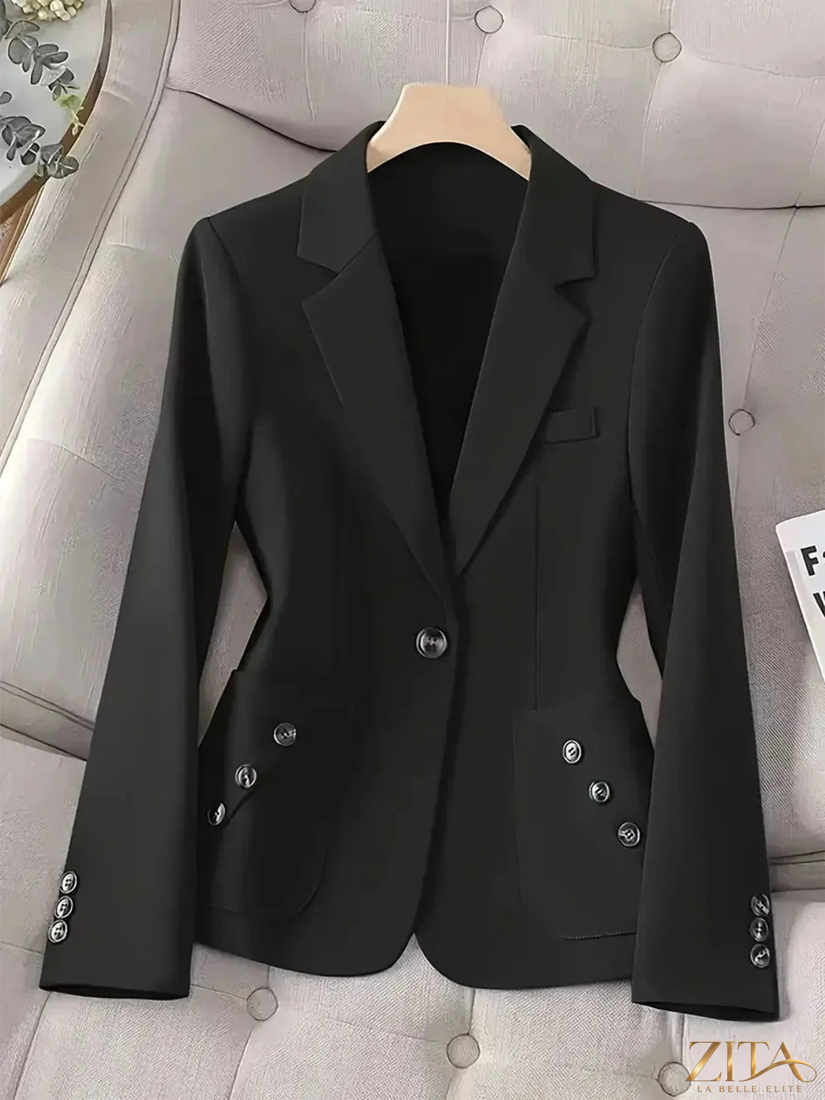 Black one-button blazer with front pockets, stylish and tailored, by Trendsi. Perfect for professional or casual outfits.