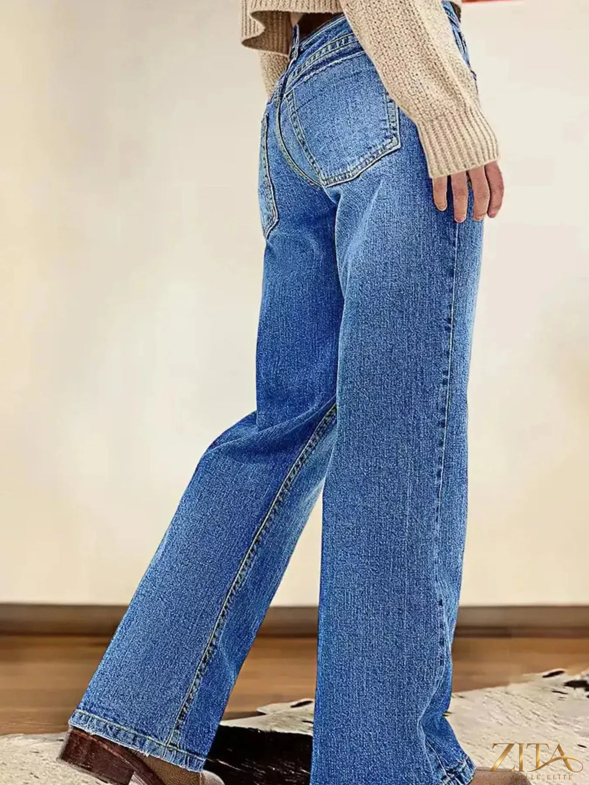 Zita La Belle Elite vintage wash straight-leg jeans with classic fit and distressed details, displayed on a hanger.
