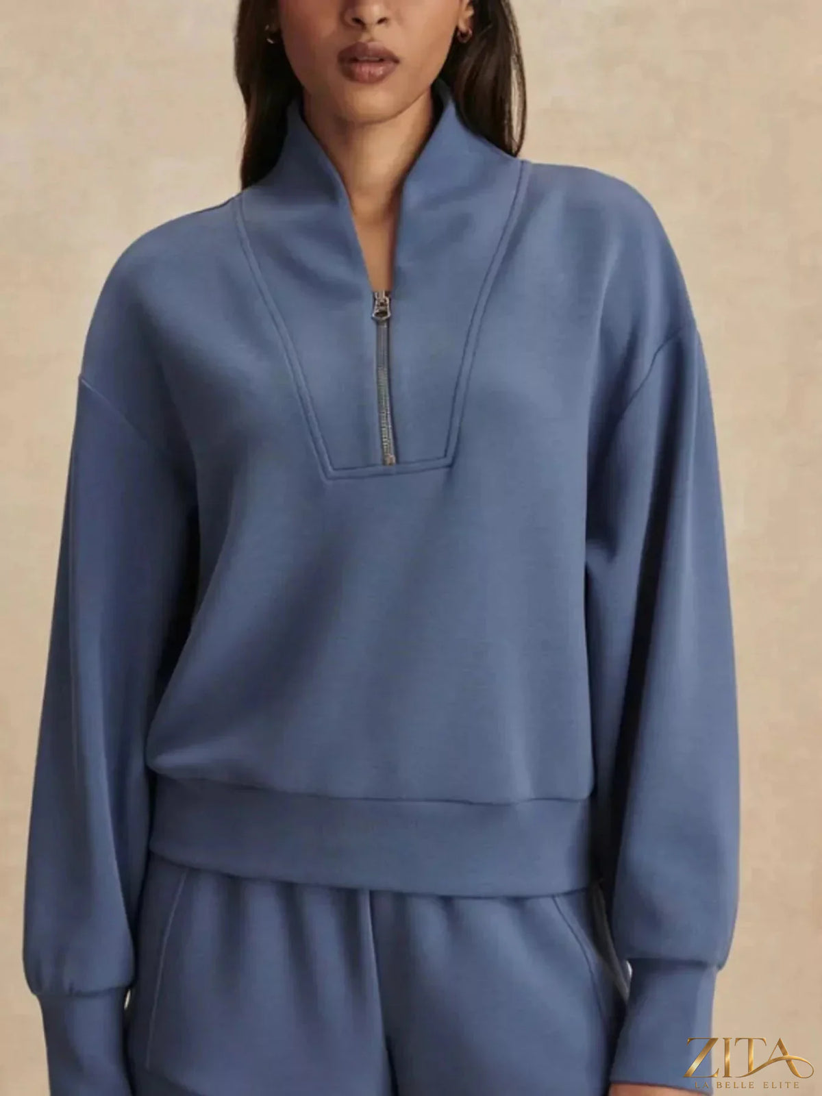 Zita La Belle Elite quarter-zip sweatshirt and wide-leg pants set displayed on a hanger, in neutral tones.