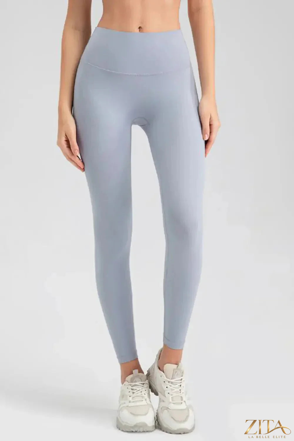 Dark gray wide waistband sport leggings by Trendsi, showing a close-up of the stretchy fabric and comfortable fit.