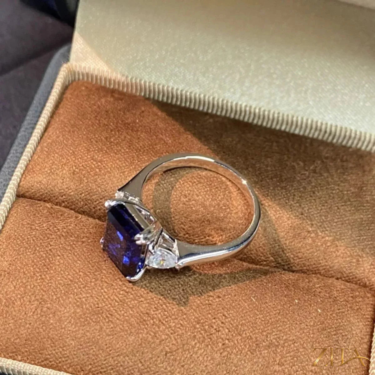 925 sterling silver ring with blue sapphire gemstone and geometric design, showcasing a modern, elegant jewelry piece.