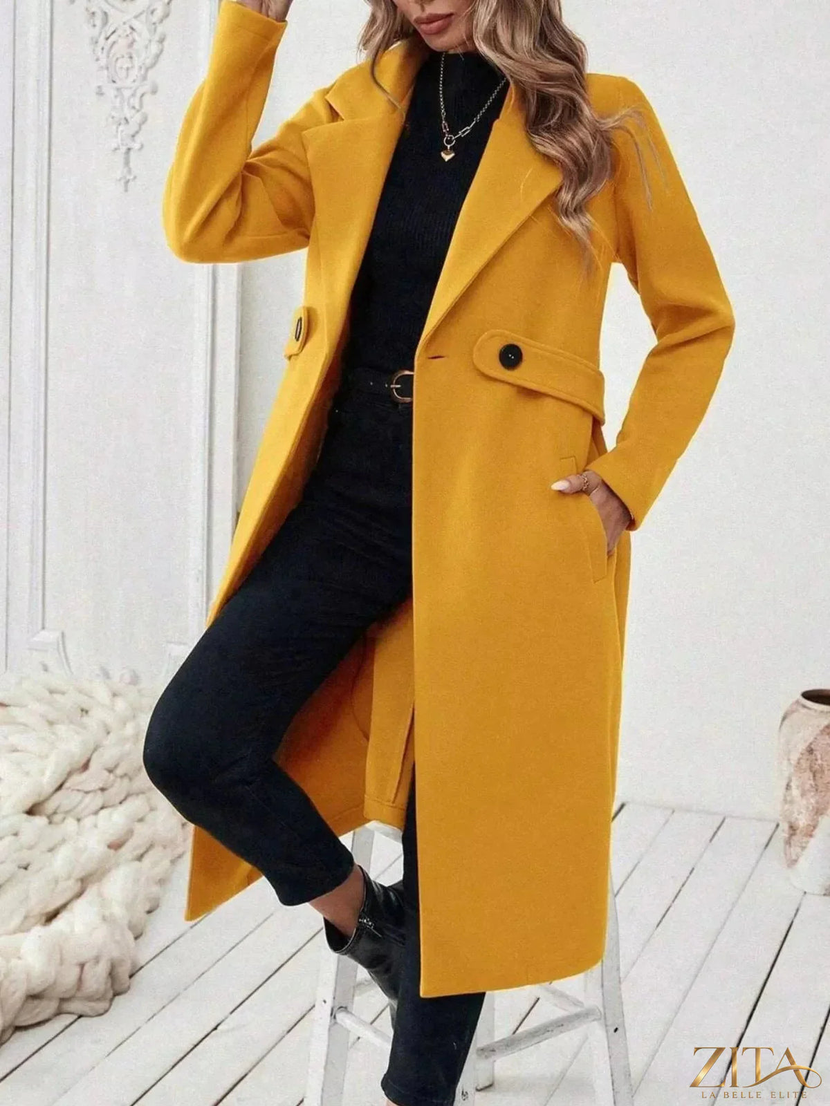 Zita La Belle Elite single-button longline coat in neutral fabric, displayed on a hanger with a minimalist background.