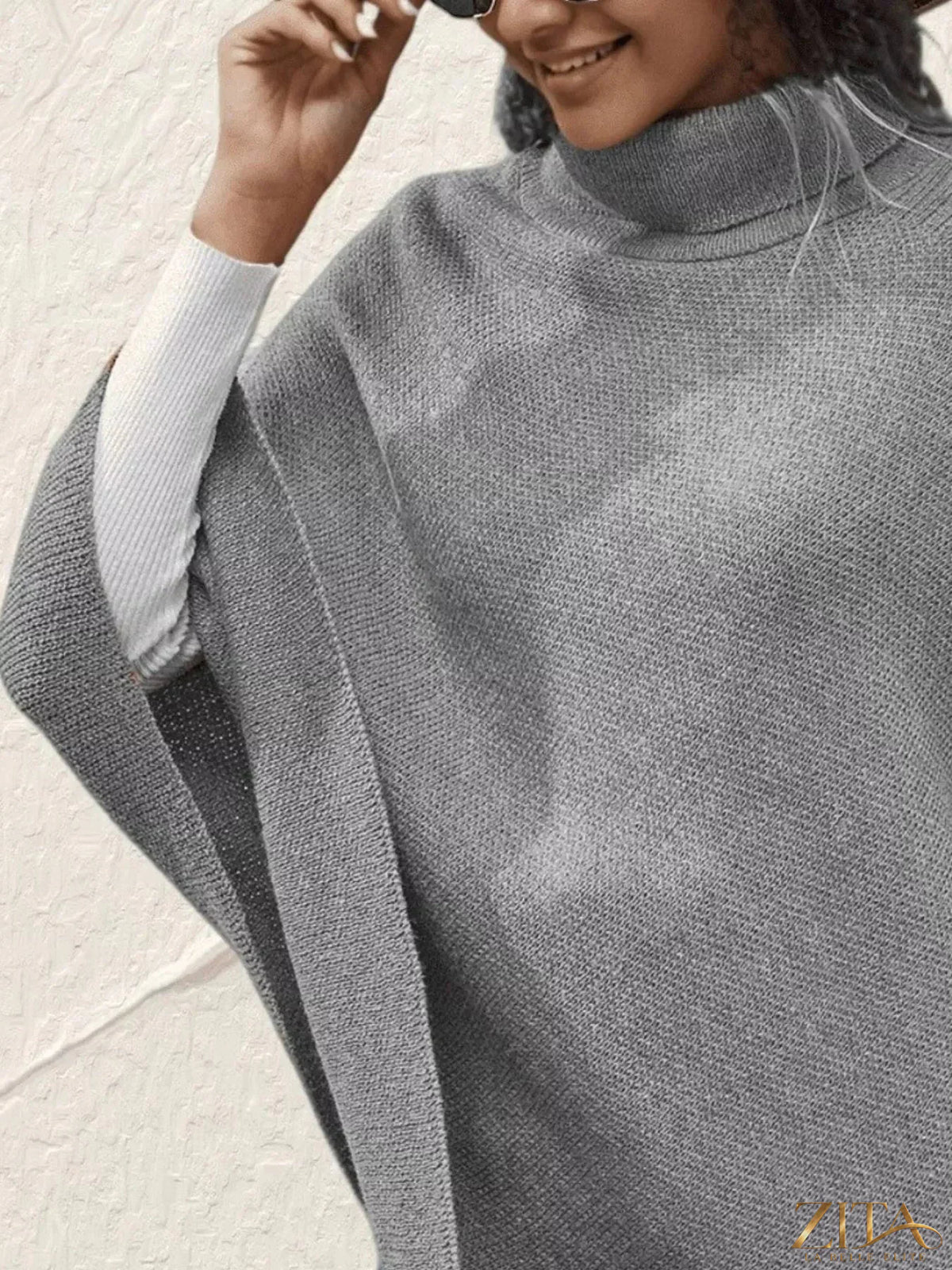 Zita La Belle Elite button-decor turtleneck poncho pullover in soft knit fabric, featuring a stylish high neckline with button accents.