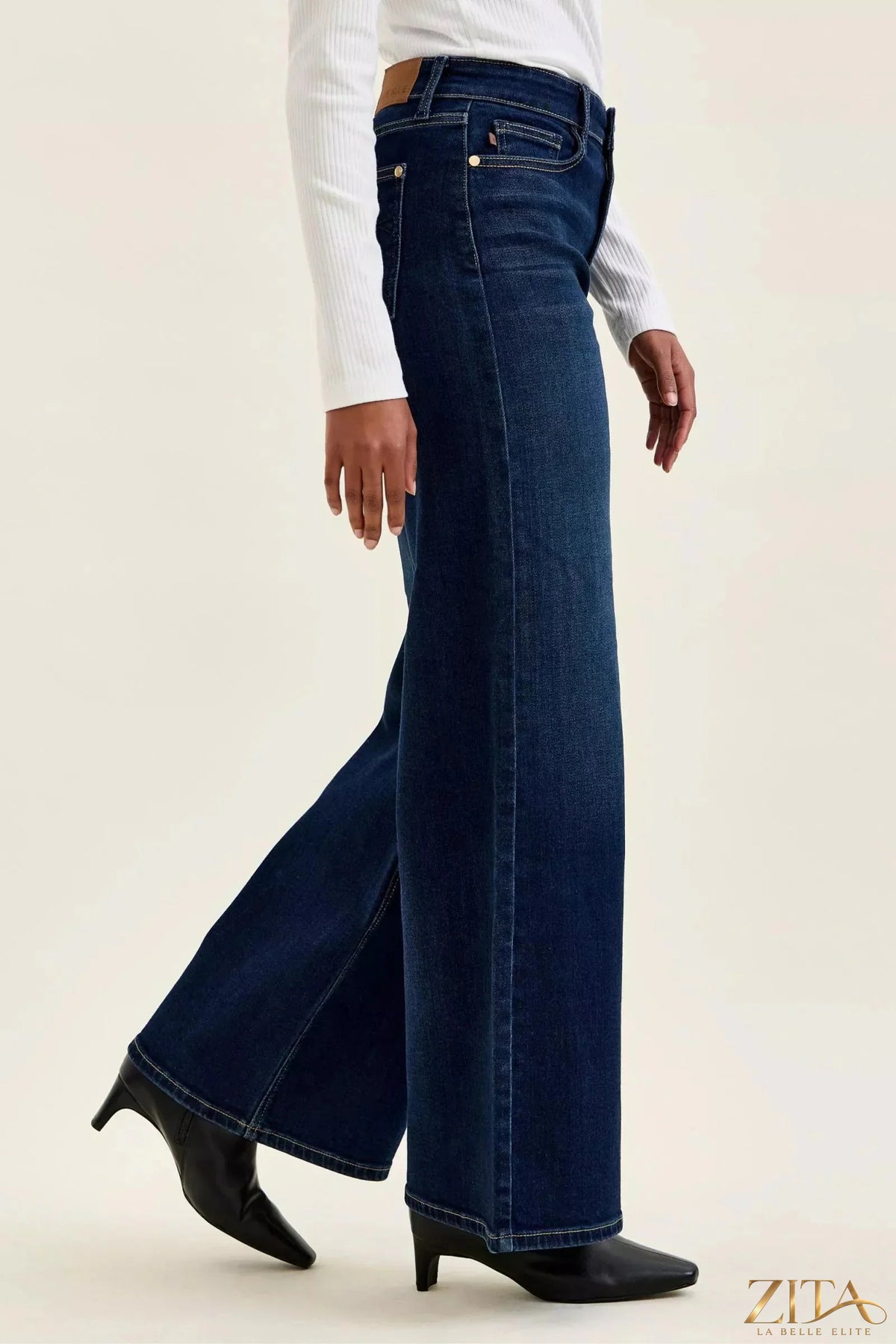 Dark wash Judy Blue high-waisted wide-leg jeans with belt loops and front pockets, styled on a mannequin.