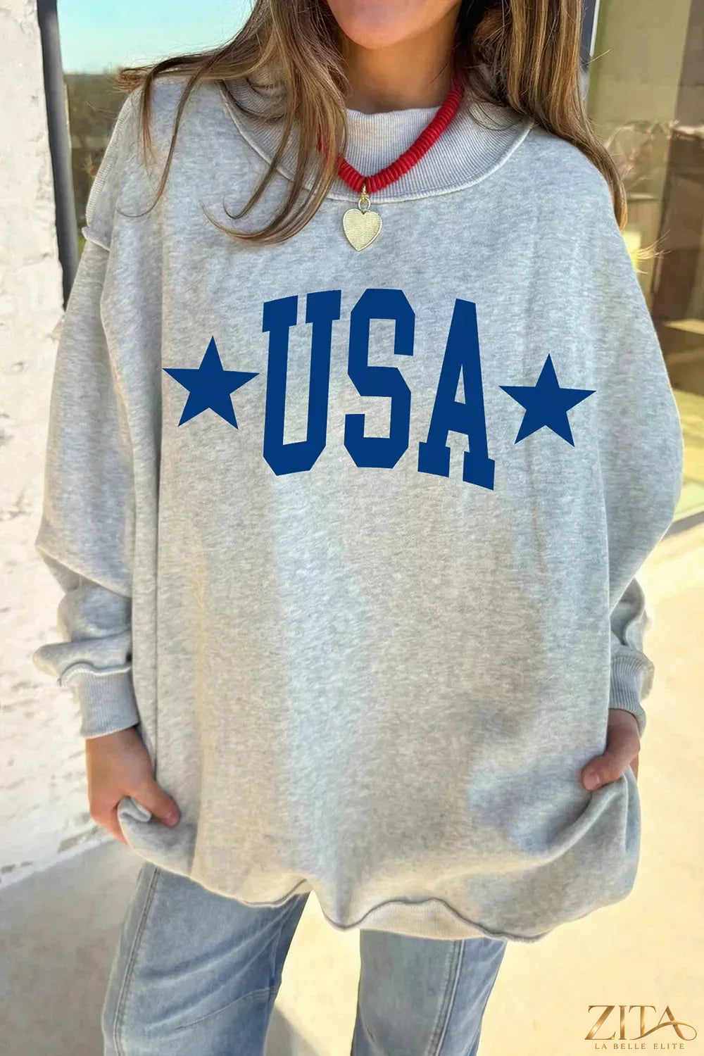 Zita La Belle Elite Mock Neck USA Slogan Graphic Sweatshirt in black with bold white USA text on the front.