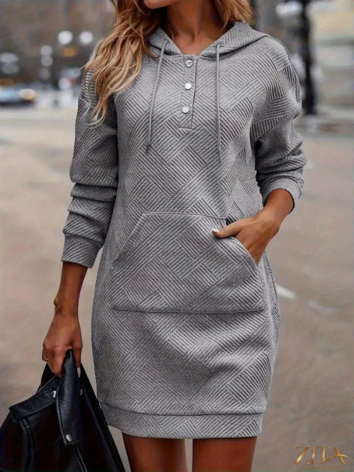 Zita La Belle Elite casual textured hooded sweatshirt dress hanging on a wooden hanger showing soft fabric and relaxed fit.