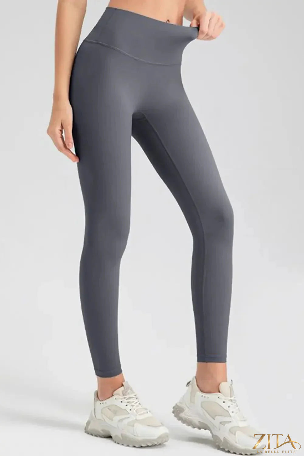 High-waisted Trendsi sport leggings with wide waistband, stretchy fabric, and seamless design for activewear and workout comfort.